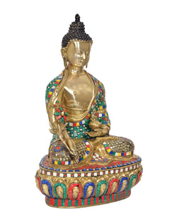 Brass Buddha statue in meditation pose, full figure view with jeweled details on robe