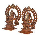 Brass Lakshmi and Ganesha idols, side view, seated with detailed arch halo frames