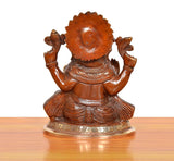 Brass Ganpati Bappa murti, back view; textured hair, shoulder arms raised, embossed base.