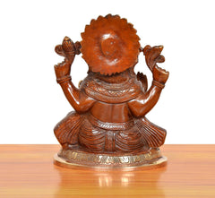 Brass Ganpati Bappa murti, back view; textured hair, shoulder arms raised, embossed base.