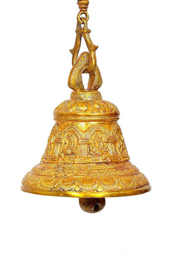 Close-up of antique brass Ganesha bell showing detailed bands and hanging loop