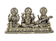 Front view brass Ganesha Lakshmi Saraswati showpiece on engraved pedestal