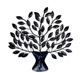 Black iron tree wall hanging with dark metal leaves and curved trunk pedestal base