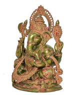 Brass Ganesha sitting idol close-up, green-gold finish with red-gold patterned crown