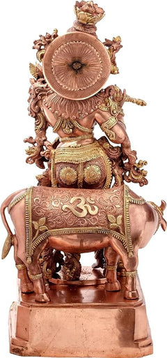 Krishna on cow statue, copper-toned brass, rear view with circular halo detail