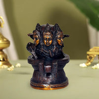 Brass Shiva linga statue with three engraved heads, front view on pedestal