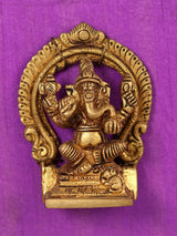 Gold Ganesha brass statue with crown and ornaments, framed on purple cloth