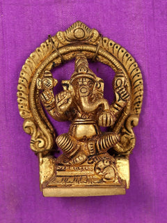 Gold Ganesha brass statue with crown and ornaments, framed on purple cloth