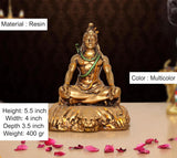 Resin Lord Shiva sculpture, seated posture; multicolor accents, gold figure and green sash.