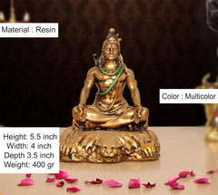 Resin Lord Shiva sculpture, seated posture; multicolor accents, gold figure and green sash.