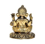 Brass Ganesha idol close view, raised hands, intricate floral designs on base