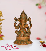 Brass Lord Ganesha idol with multiple arms, seated on a lotus base