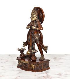 Brass Hanuman idol side view, curved halo-like back arch, detailed jewelry and crown