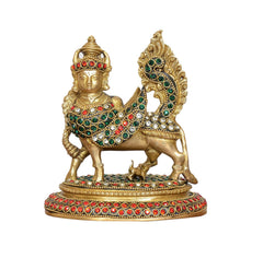Brass Kamadhenu cow idol, front view with gemstone-like red and green ornaments