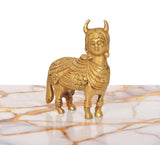 Brass Kamdhenu cow figurine, golden finish, smiling face side view