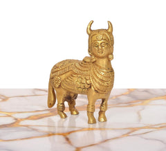Brass Kamdhenu cow figurine, golden finish, smiling face side view