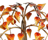 Metal bodhi tree trunk with detailed leaf cutouts, no face visible