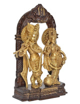 Brass Radha Krishna idol statue front view with dark frame arch and gold figures
