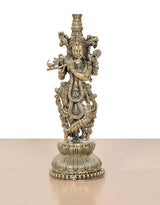 Lord Krishna brass sculpture playing flute, detailed crown and flowing ornaments