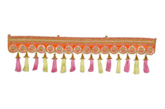 AONA toran bandhanvaar door decoration with multicolor tassels along an ornate orange trim.
