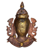 Back view of Shiva wall hanging mask idol, dark frame with gold-toned oval face