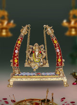 Brass Ganesha swing showpiece with red-gold decorated arms and chains, seated on platform