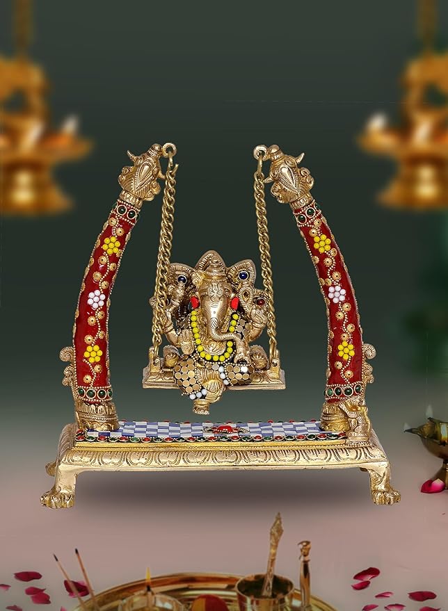 Brass Ganesha swing showpiece with red-gold decorated arms and chains, seated on platform