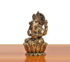 Bronze Lord Ganesha idol, side view with four arms, seated on ornate base