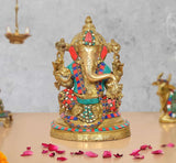 Brass Lord Ganesha idol, seated with colorful jeweled detailing and ornate gold base.