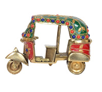 Brass auto rickshaw decor, side view with green canopy, red emblem panels, gold wheels