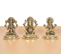 Brass Lakshmi Ganesha Saraswati Idols, front view of three seated figures, gold-tone