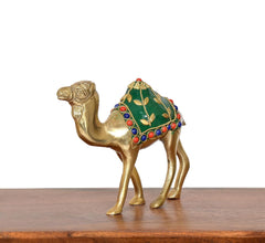 Brass camel figurine facing left, green saddle with floral design and bead accents