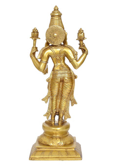 Brass Lakshmi figurine with detailed back disc, four arms raised, standing on pedestal base.