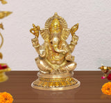 Ganesha idol statue, gold-tone four-armed seated on lotus base