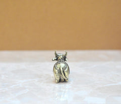 Brass Nandi bull figurine, rear view with patterned saddle detailing
