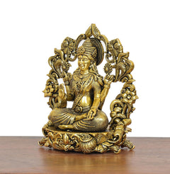 Lakshmi Maa brass idol front view, ornate floral arch and jewelry, seated on base