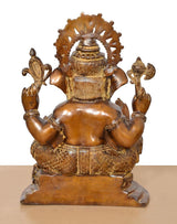 Back view of brass Ganesha statue, brown, carved halo and seated back details