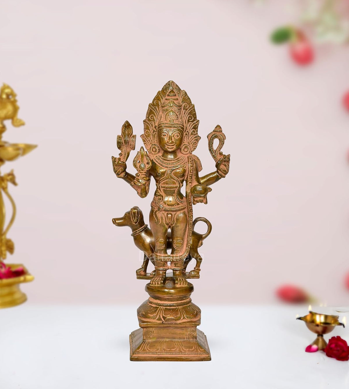 Brass Kal Bhairava deity idol with multiple arms on an ornate pedestal