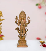 Brass Kal Bhairava deity idol with multiple arms on an ornate pedestal