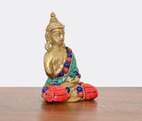 Meditating brass Buddha statue, seated posture, green sash with red and blue bead strands