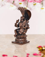 Copper Lakshmi Narasimha figurine, side angle showing raised arms and crown