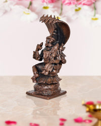 Copper Lakshmi Narasimha figurine, side angle showing raised arms and crown