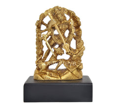 Close view of golden brass Durga idol with raised sword, arched back, black base.