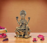 Lakshmi brass deity on lotus base, raised hands and jeweled crown detail