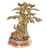 Brass Buddha tree showpiece from side, seated Buddha beside ornate jeweled branches
