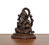 Lord Ganesha murti side view, raised trunk and richly detailed seated posture