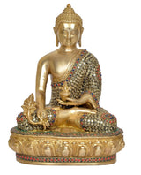 Gold brass Buddha idol seated cross-legged, patterned jeweled robe and haloed base