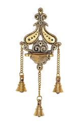 Brass wall diya with ornate peacock-like frame and three bells on chains