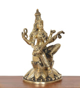 Brass Saraswati deity idol seated on lotus base, veena across lap