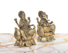 Angled view of Lakshmi and Ganesh brass statue pair, textured detailing on robes